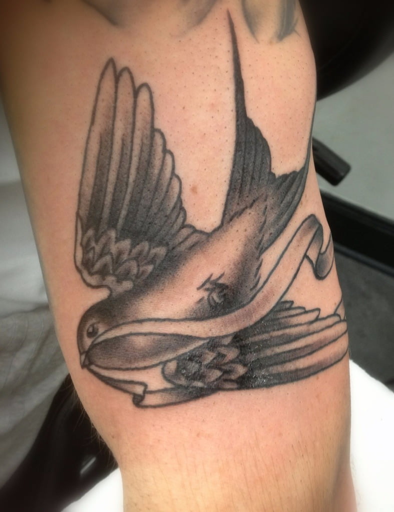 Black and grey swallow tattoo